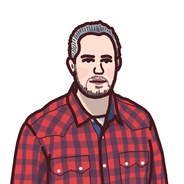 A person with short grey hair, wearing a red checkered shirt.