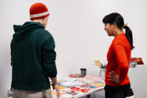 Two people looking at a table of flyers